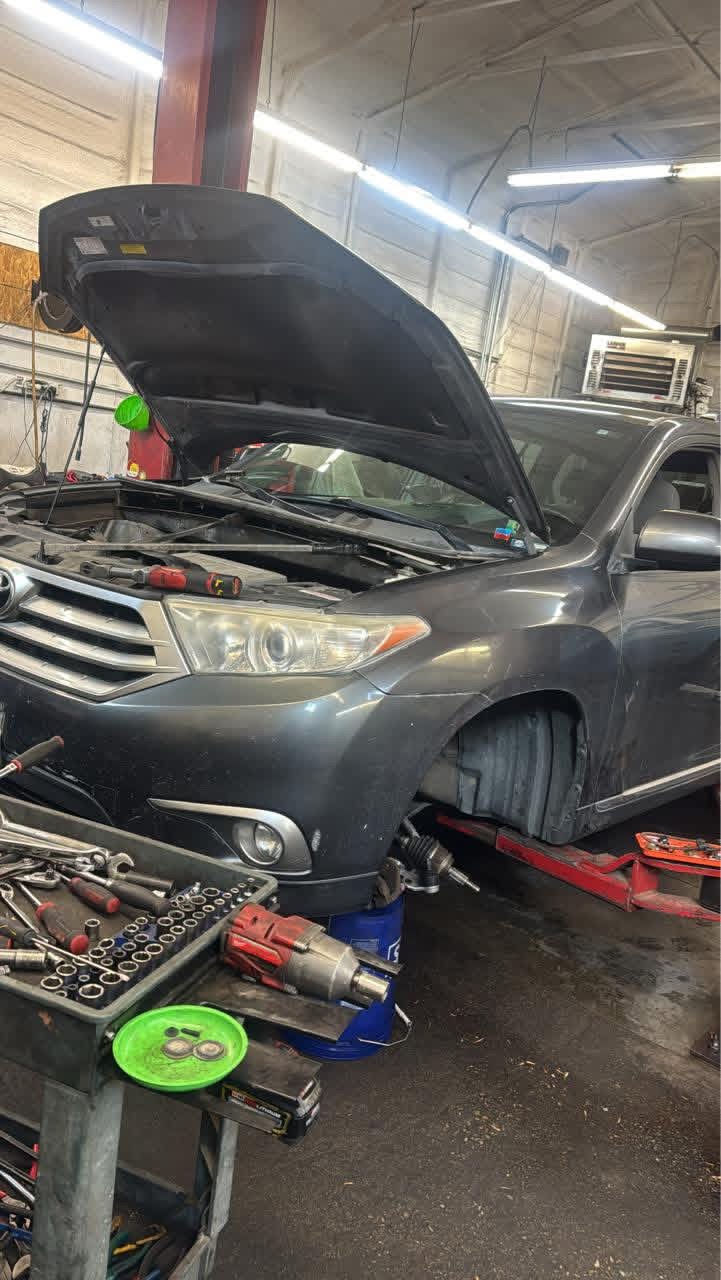 Vehicle raised on a lift with the hood open during a Recovery Automotive repair